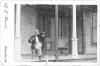 W. W. Edwards playing violin on his porch